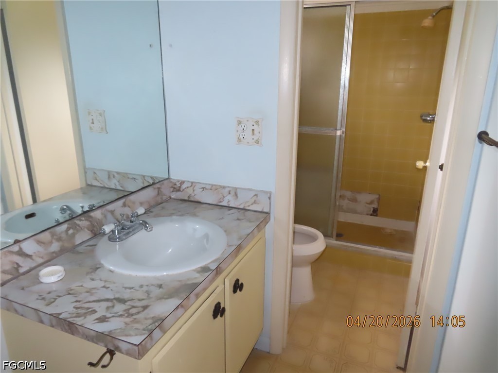 6025 Pine Lane Sebring, FL 33876 - Photo 8 of 12 a bathroom with a granite countertop sink a toilet and shower