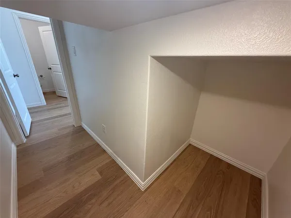 a view of a room with wooden floor