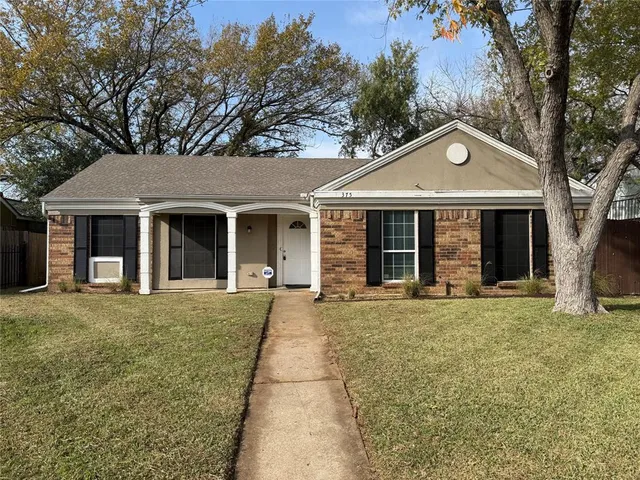 front view of a house with a garden