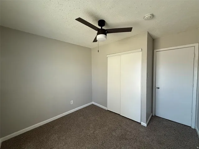 a view of a room with a ceiling fan