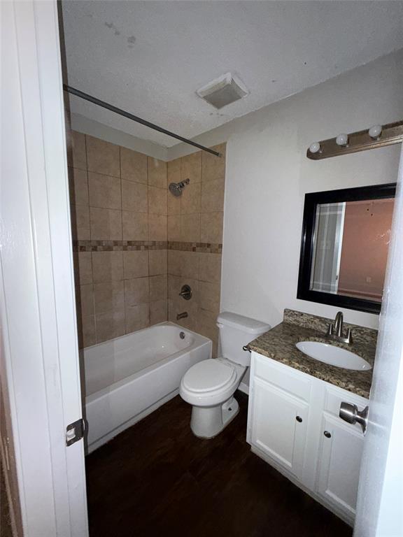 375 Ancestry Lane Dallas, TX 75217 - Photo 16 of 19 a bathroom with a granite countertop sink a toilet a mirror and bathtub