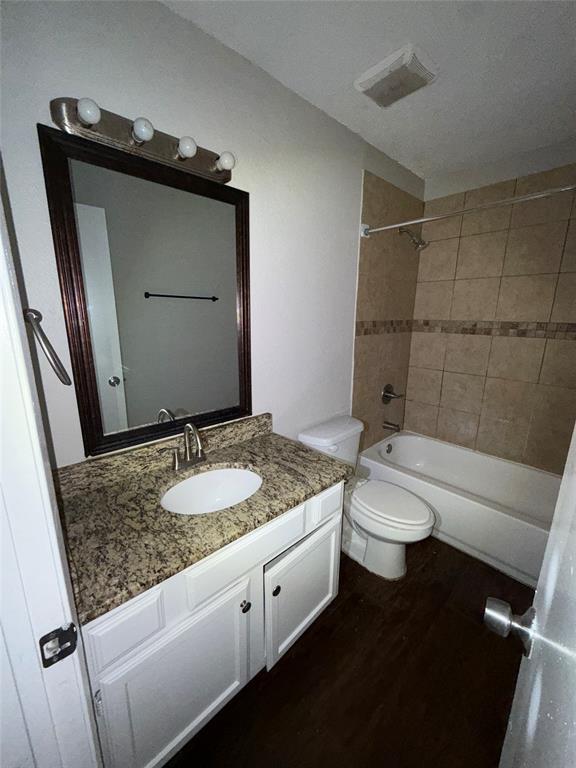 375 Ancestry Lane Dallas, TX 75217 - Photo 17 of 19 a bathroom with a granite countertop sink toilet and shower