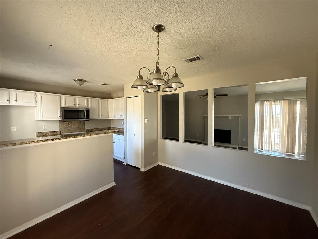 375 Ancestry Lane Dallas, TX 75217 - Photo 4 of 19 a kitchen with stainless steel appliances a refrigerator and a stove top oven