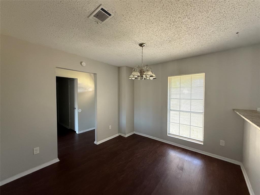 375 Ancestry Lane Dallas, TX 75217 - Photo 5 of 19 an empty room with wooden floor and windows