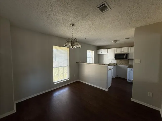 a view of a kitchen with a sink dishwasher and a fireplace