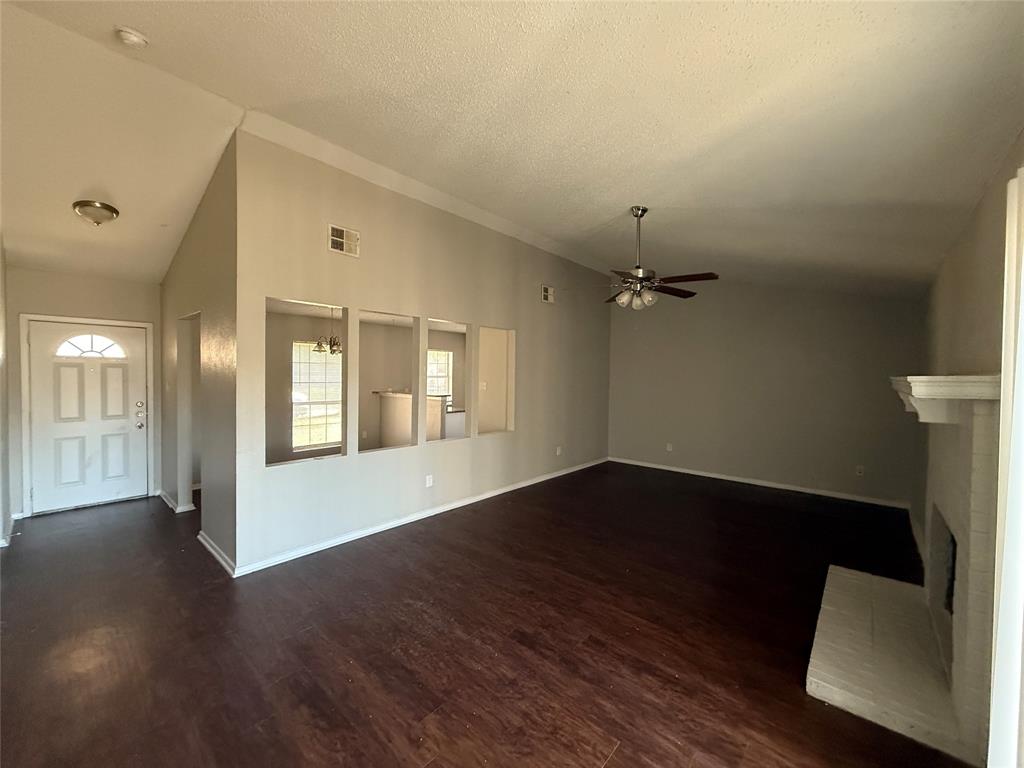 375 Ancestry Lane Dallas, TX 75217 - Photo 9 of 19 an empty room with wooden floor and windows