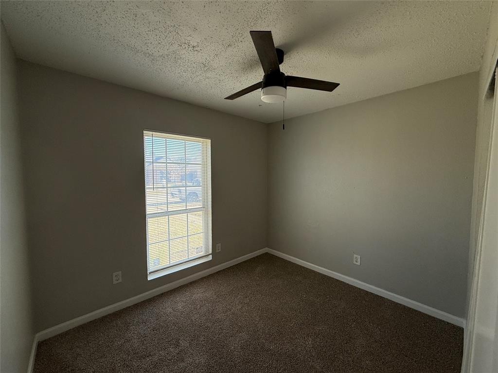 375 Ancestry Lane Dallas, TX 75217 - Photo 10 of 19 an empty room with a window and ceiling fan
