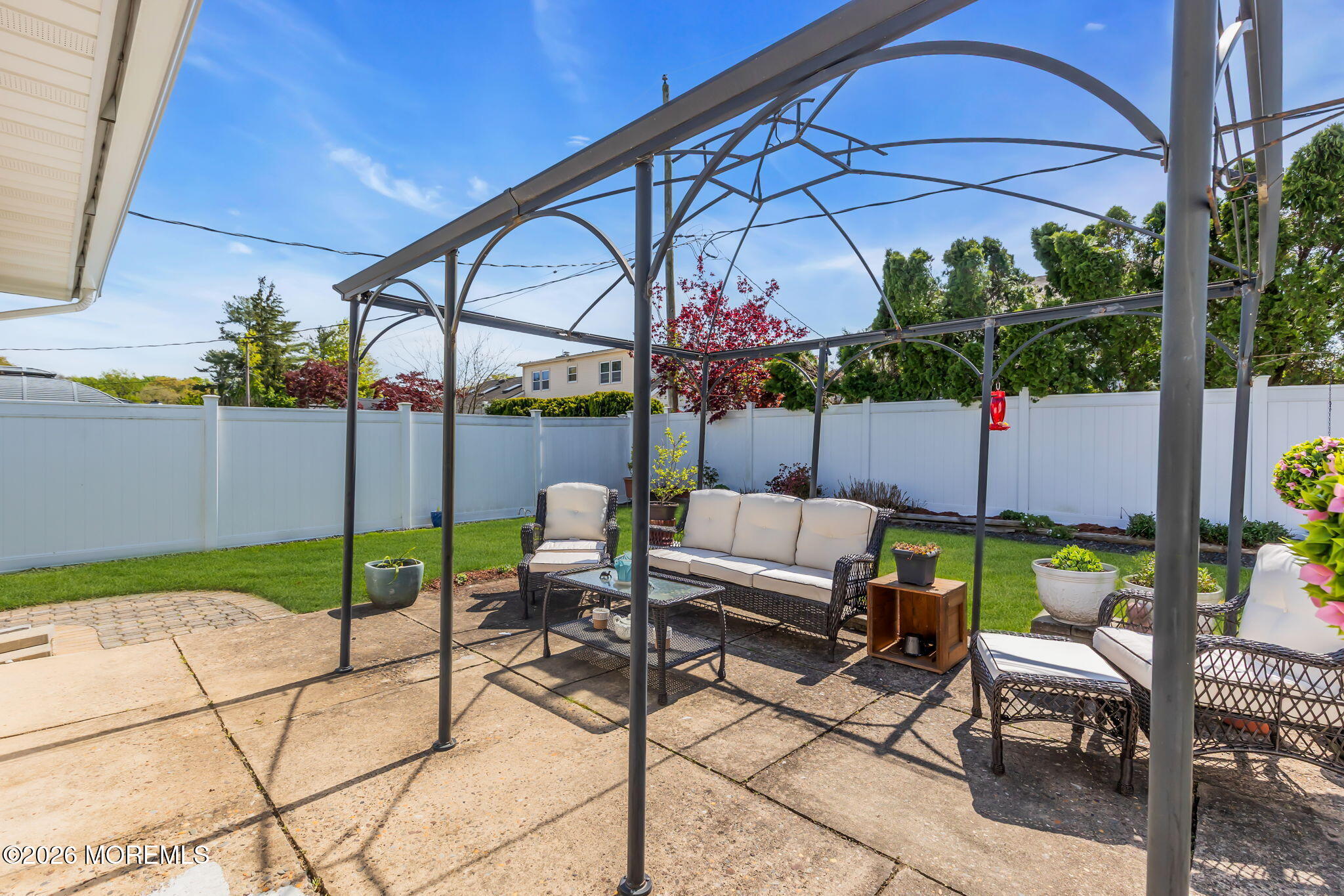 101 Andover Lane Matawan, NJ 07747 - Photo 44 of 51 a view of patio with a table and chairs under an umbrella