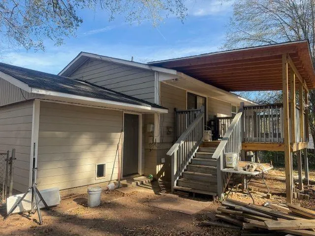 a view of a patio with table and chairs