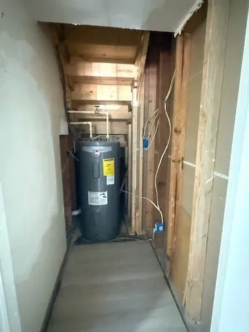 a room with water heater and stairs