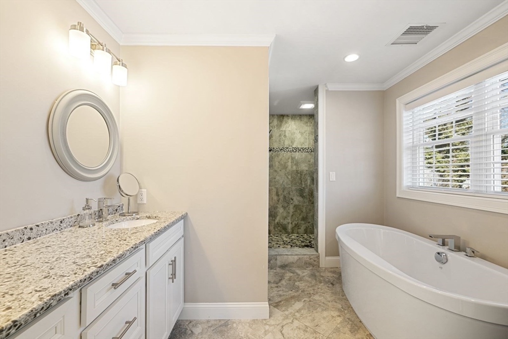 7 Hayes Road Hingham, MA 02043 - Photo 14 of 34 a bathroom with a granite countertop sink a mirror and a bathtub