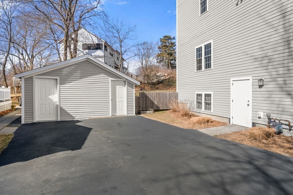 7 Hayes Road Hingham, MA 02043 - Photo 29 of 34 a front view of a house with a yard and garage