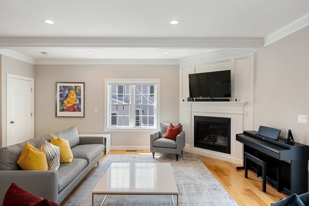 7 Hayes Road Hingham, MA 02043 - Photo 4 of 34 a living room with furniture a flat screen tv and a fireplace