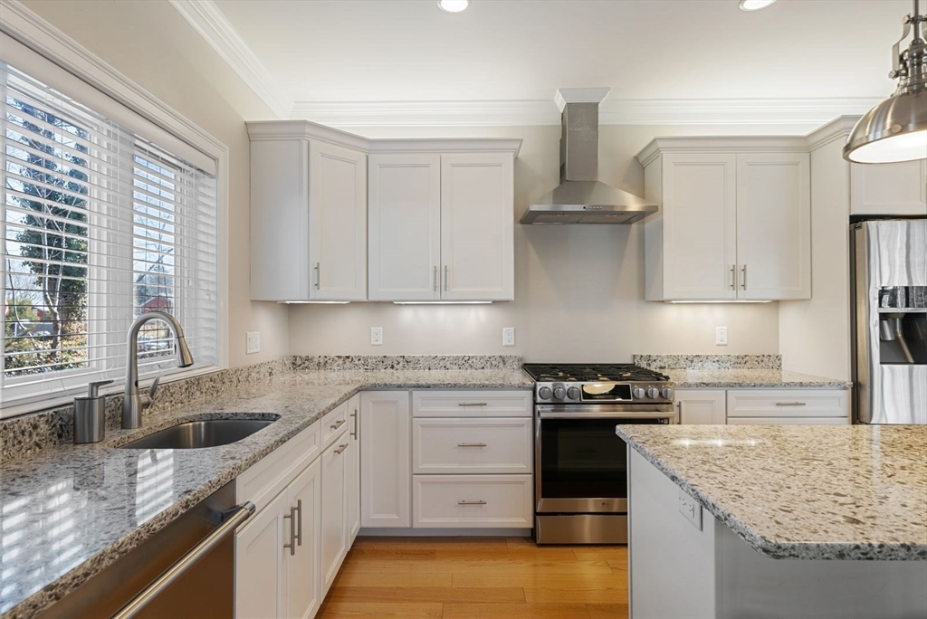 7 Hayes Road Hingham, MA 02043 - Photo 9 of 34 a kitchen with stainless steel appliances granite countertop a sink stove and refrigerator