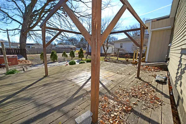 a view of a street with wooden fence