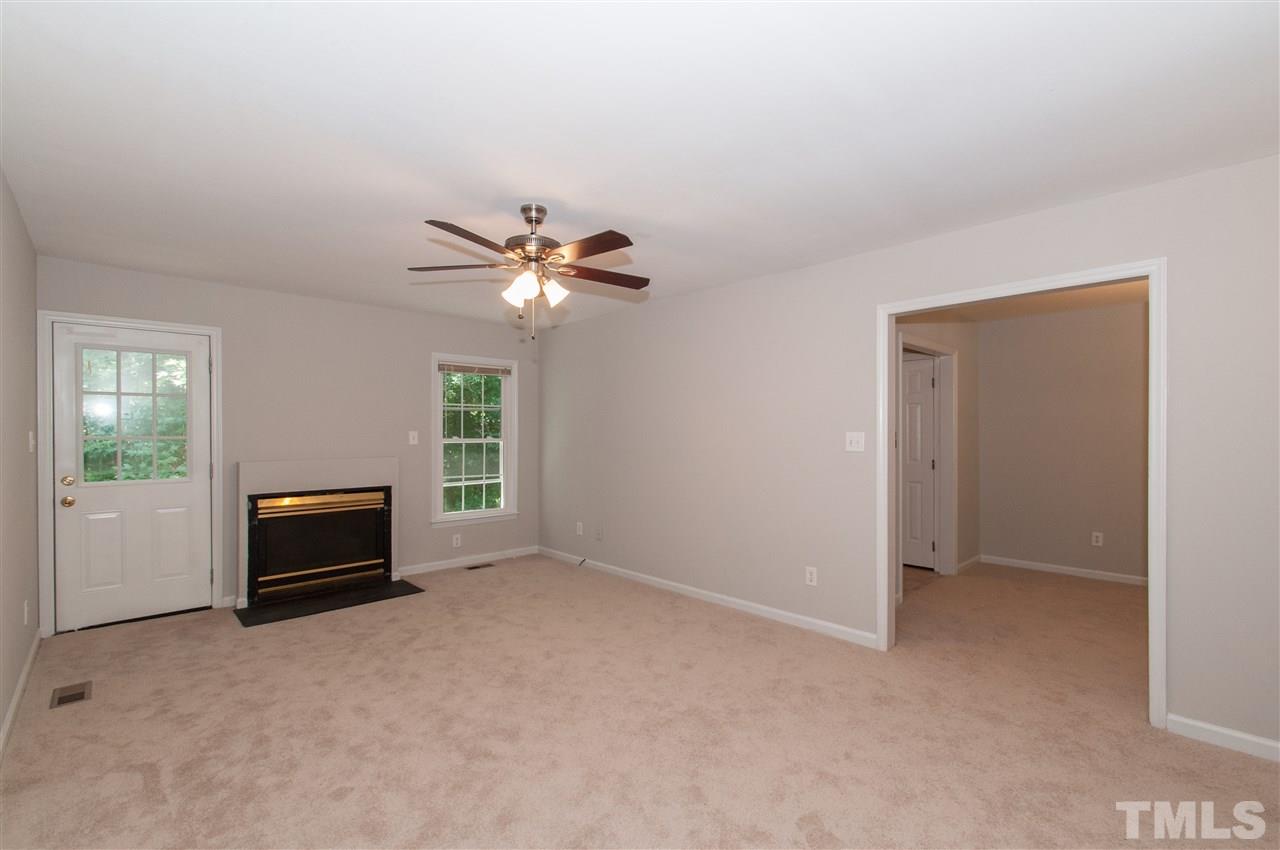 5960 Sandy Run Knightdale, NC 27545 - Photo 2 of 13 an empty room with windows and chandelier fan