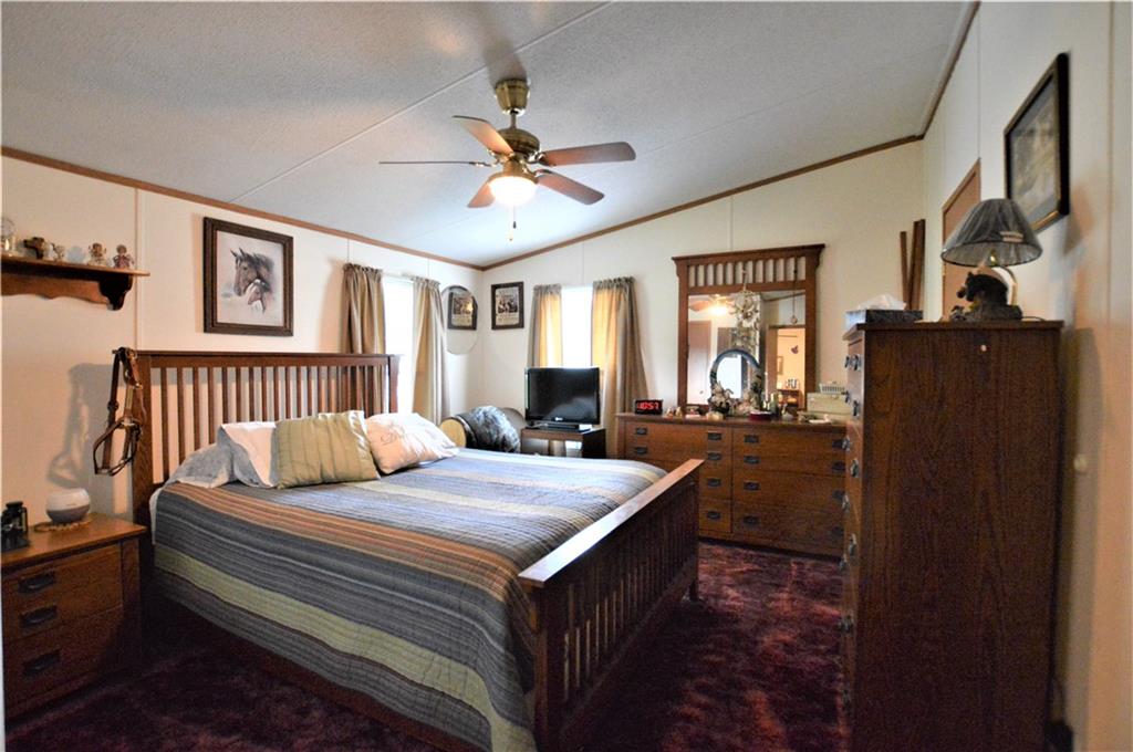 4015 Beach Road Hudson, NC 28638 - Photo 11 of 22 a bedroom with a bed and a chandelier