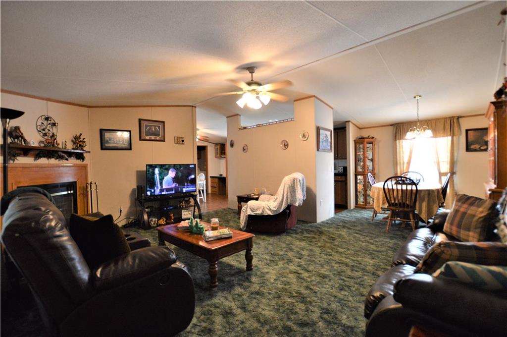 4015 Beach Road Hudson, NC 28638 - Photo 4 of 22 a living room with furniture a fireplace and a flat screen tv