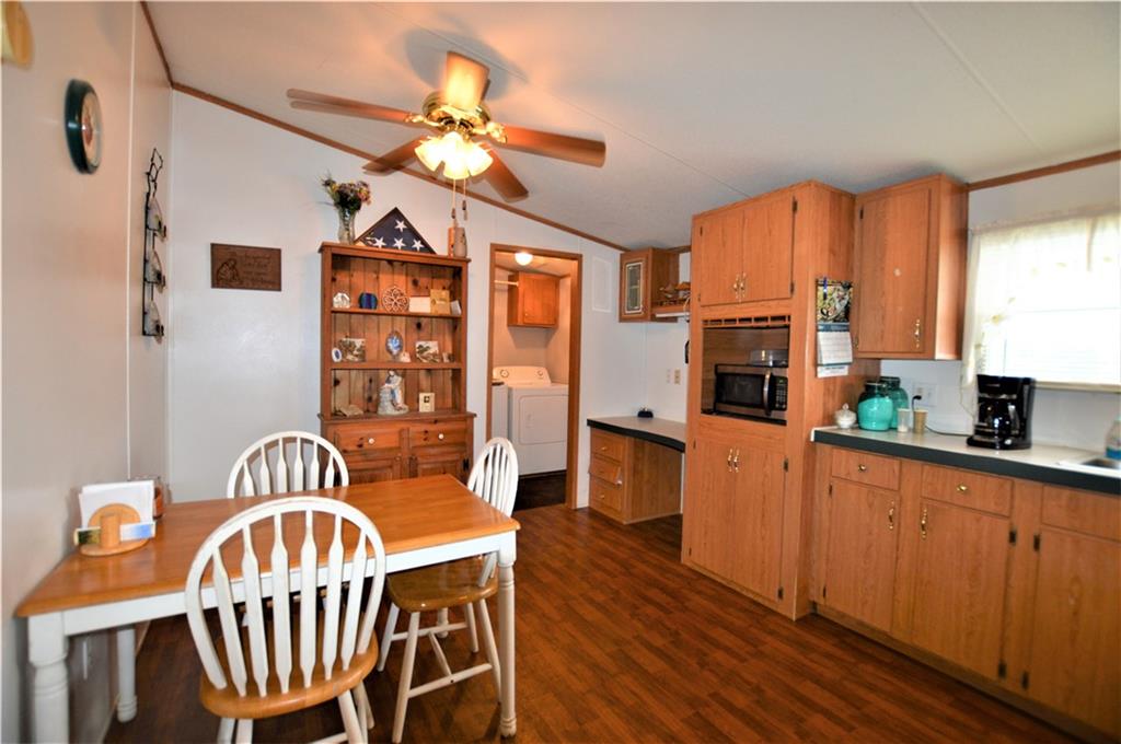 4015 Beach Road Hudson, NC 28638 - Photo 8 of 22 a kitchen with stainless steel appliances a table chairs and chandelier