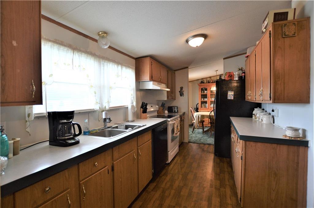 4015 Beach Road Hudson, NC 28638 - Photo 10 of 22 a kitchen with stainless steel appliances granite countertop a sink a stove cabinets counter space and a window
