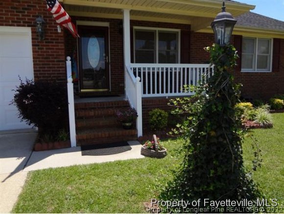 6400 Faircloth Bridge Road Stedman, NC 28391 - Photo 1 of 19 a view of a house with a small yard and flower plants