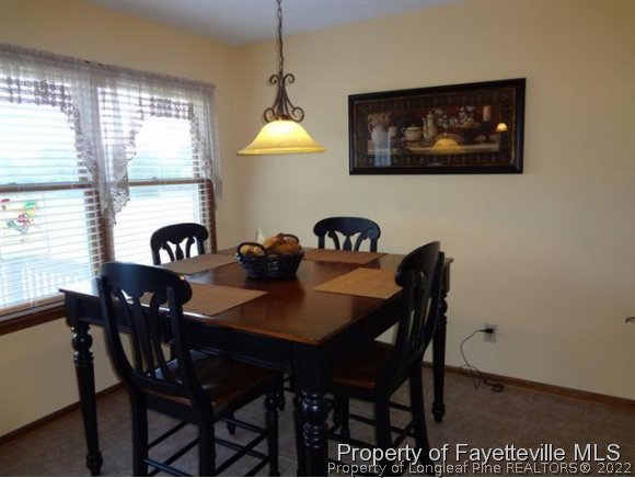 6400 Faircloth Bridge Road Stedman, NC 28391 - Photo 11 of 19 a view of a dining room with furniture window and outside view