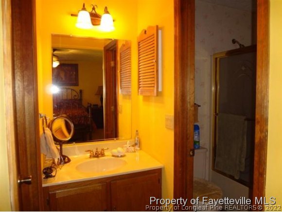 6400 Faircloth Bridge Road Stedman, NC 28391 - Photo 15 of 19 a bathroom with a sink and a mirror