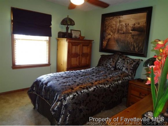 6400 Faircloth Bridge Road Stedman, NC 28391 - Photo 16 of 19 a bedroom with a bed and a painting on the wall