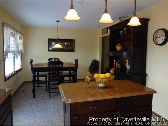 6400 Faircloth Bridge Road Stedman, NC 28391 - Photo 9 of 19 a dining room with a table and chairs