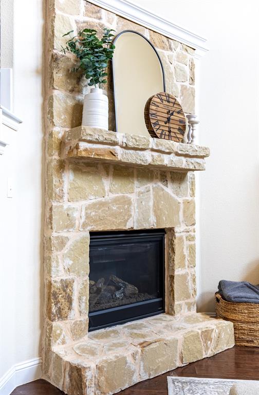 717 Rio Concho Trail McKinney, TX 75071 - Photo 8 of 37 Living room anchored by a stunning stone fireplace with stone mantel.