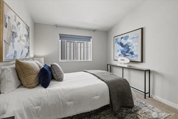 a bedroom with a large bed and a window