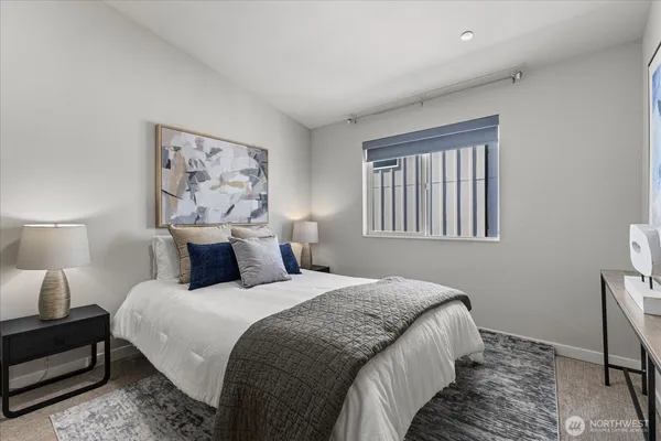 a bedroom with bed and wall painting with wooden floor