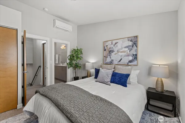 a bedroom with a bed and a lamp