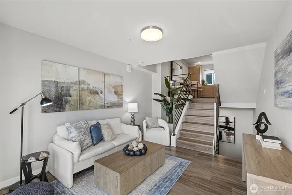 a living room with furniture and wooden floor
