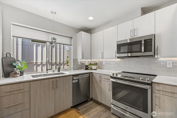 a kitchen with a sink stove and microwave