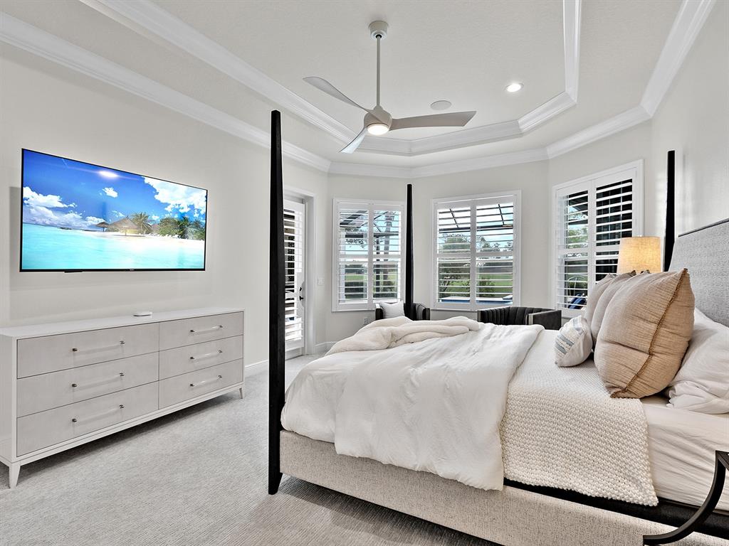 7431 Greystone Street Lakewood Ranch, FL 34202 - Photo 36 of 85 a bedroom with a bed and a flat screen tv