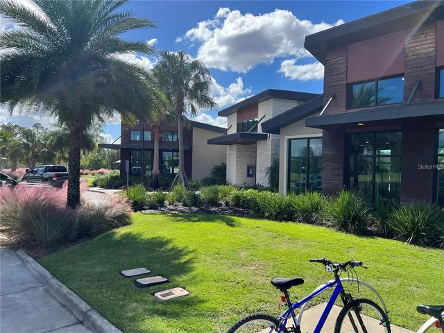 a view of an house with backyard and patio