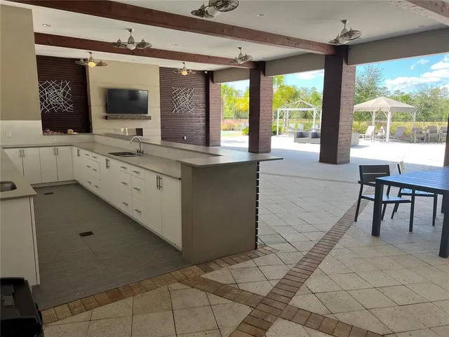 a large white kitchen with a large window