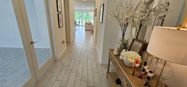 a view of a hallway with wooden floor and stairs