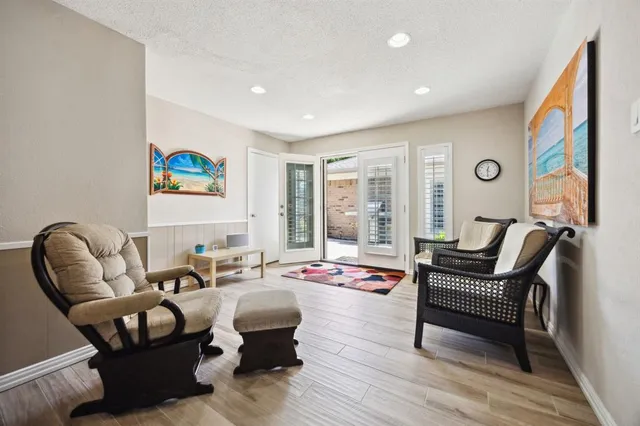 a living room with furniture and a floor to ceiling window