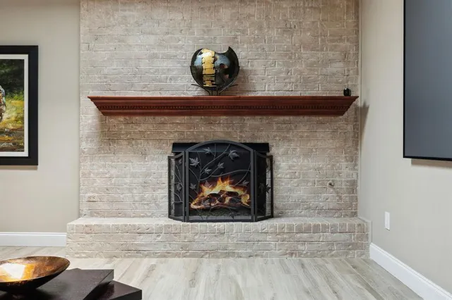 a living room with a fireplace and a wooden floor