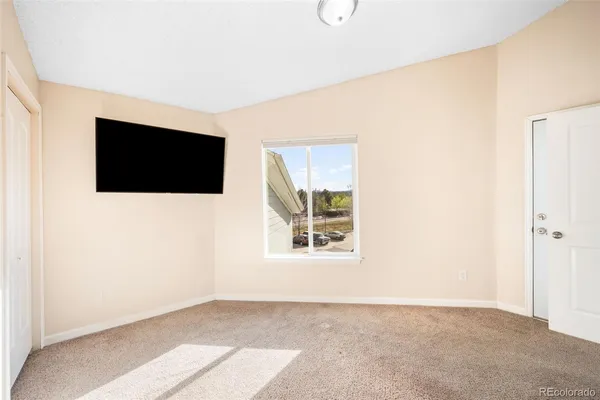 a view of an empty room with a flat screen tv