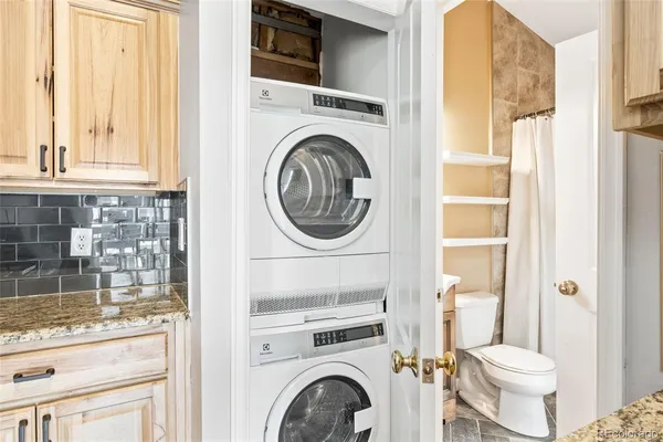 a front view of a house with a tree