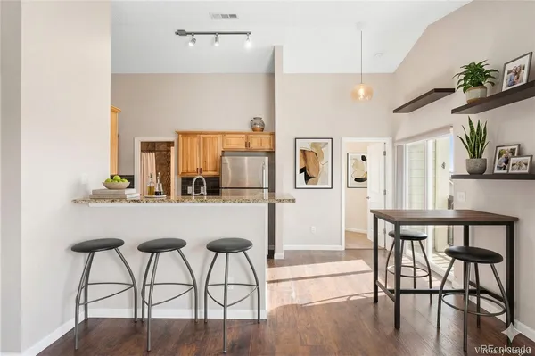 a dining room with furniture and wooden floor