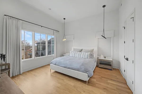 a bedroom with a bed and large window