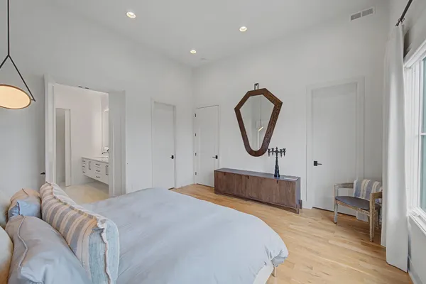 a bedroom with bed and a chandelier