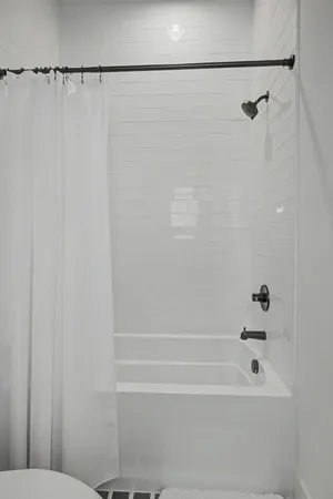 a bathroom with a shower and a toilet