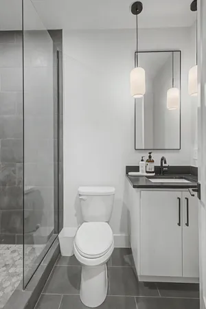 a bathroom with a toilet sink and shower