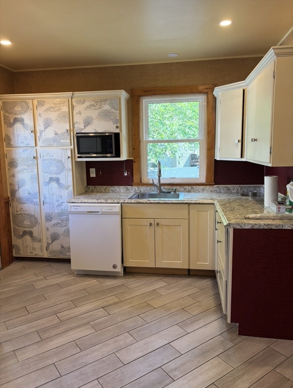13 Moulton Street Lynn, MA 01905 - Photo 11 of 18 a kitchen with stainless steel appliances granite countertop a sink cabinets and wooden floor