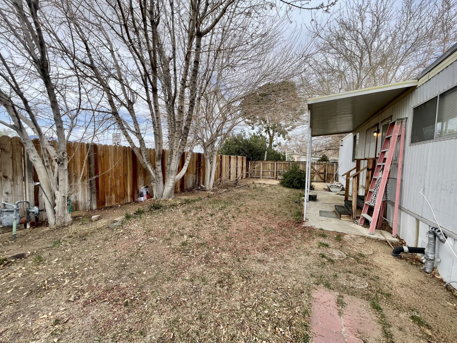 5237 Nolina Avenue Ridgecrest, CA 93555 - Photo 20 of 27 a view of a house with a backyard